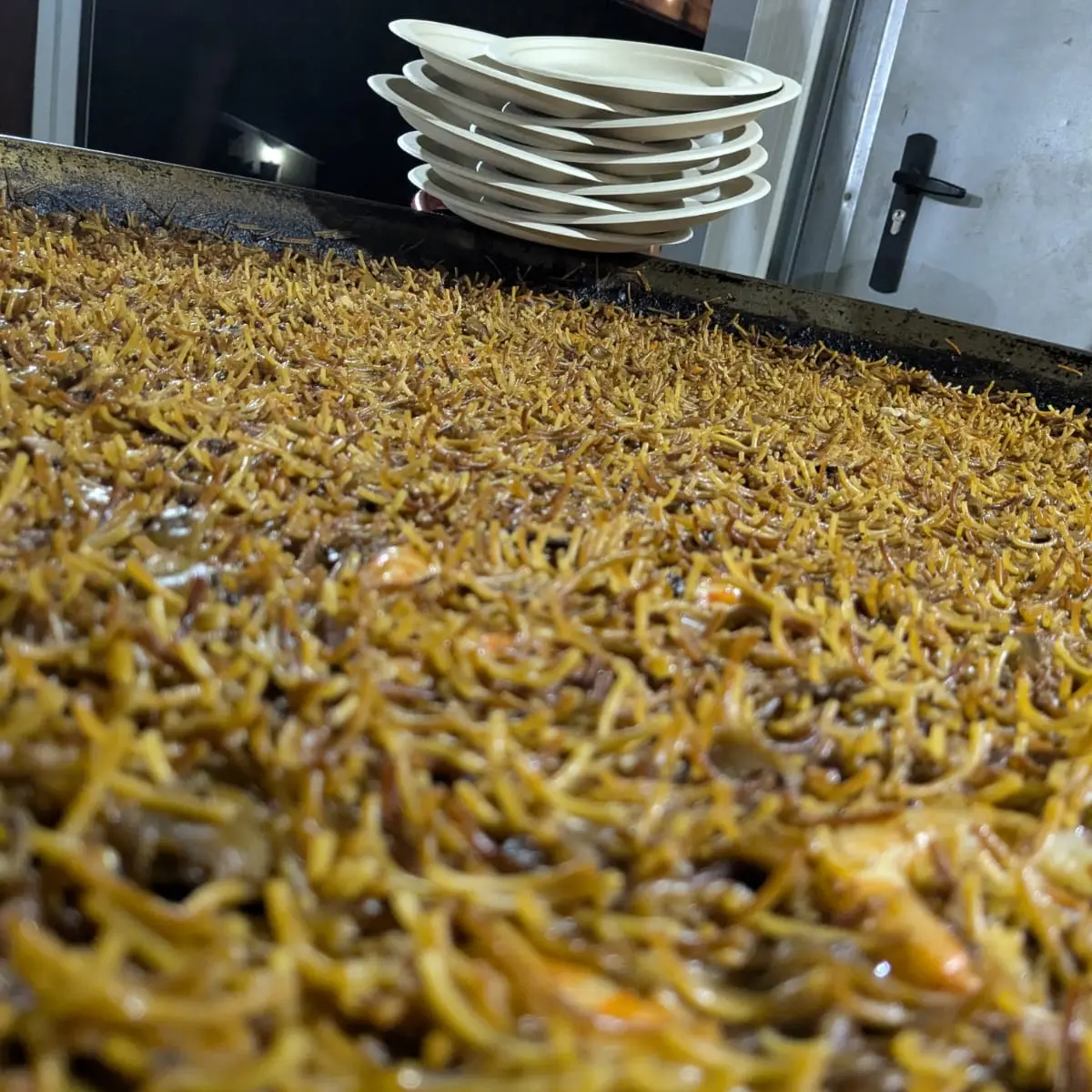 Fideuada amb calamar i gambes servida en paellera gran