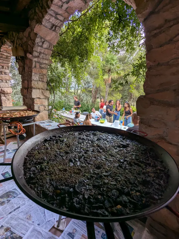 Arròs negre sota un arc de maó en un jardí